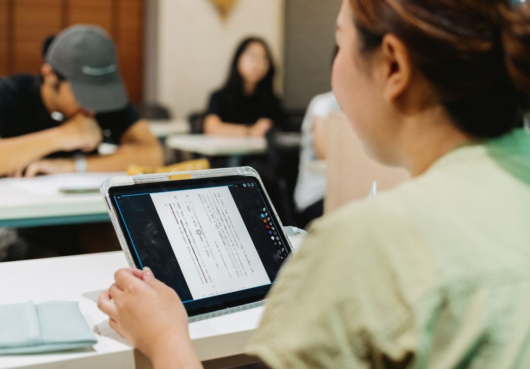 Word Scramble Unscrambler: Powerful Puzzle Solver 5 Students in a classroom working on word scramble puzzles on tablets as a vocabulary learning activity