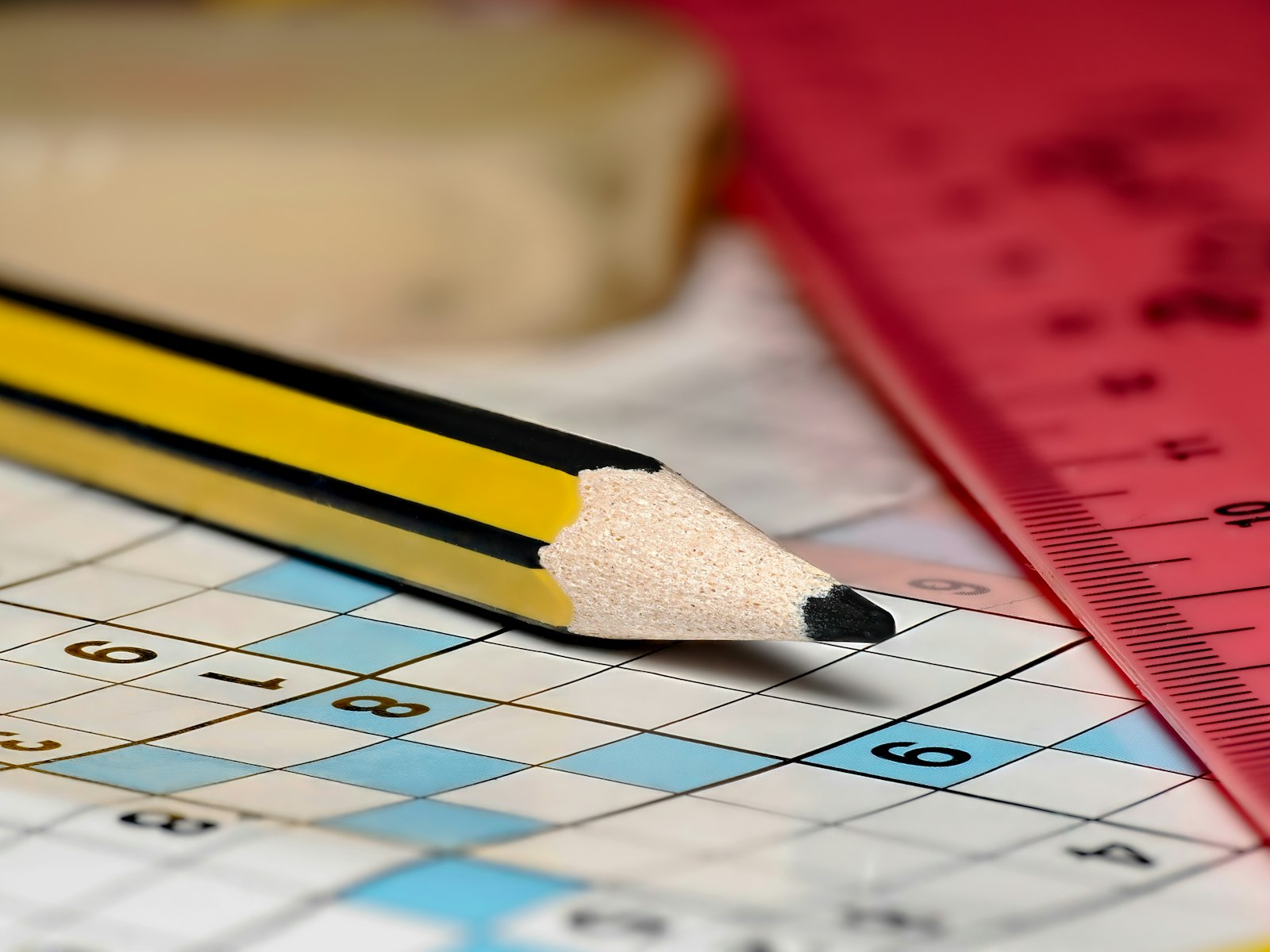 Scrambled Word Solver: Beat Any Puzzle Instantly 2 Pencil resting on a crossword puzzle being solved