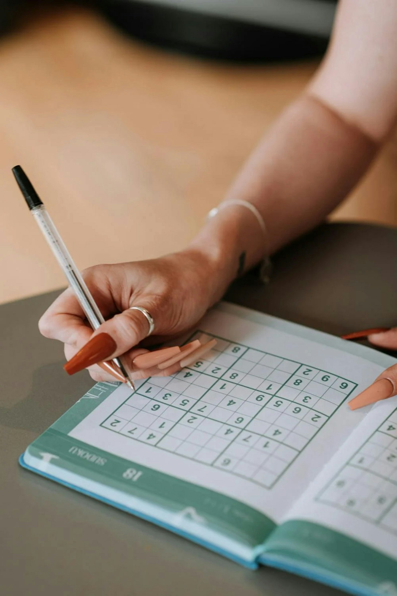 Scrambled Word Solver: Beat Any Puzzle Instantly 3 Person solving a daily word puzzle at a table